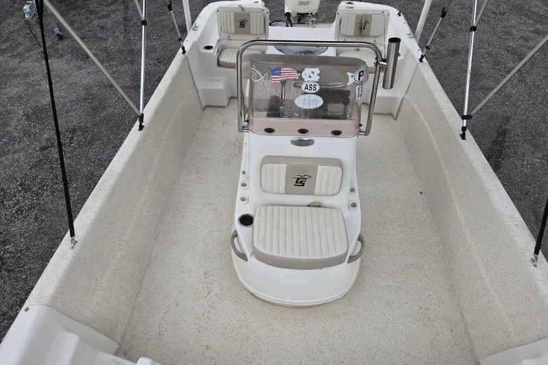 Slide: The Image of 2019 Carolina Skiff 198 DLV boat interior with seating and console, viewed from above. - 11