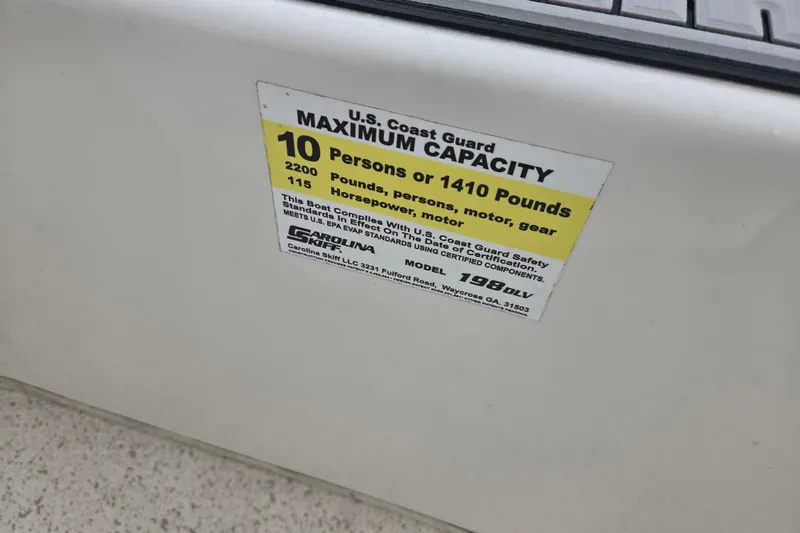 Slide: The Image of 2019 Carolina Skiff 198 DLV capacity label, 10 persons or 1410 pounds, 115 horsepower. - 12