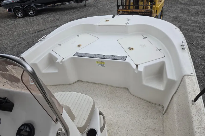 Slide: The Image of 2019 Carolina Skiff 198 DLV boat interior with storage compartments and seating. - 13