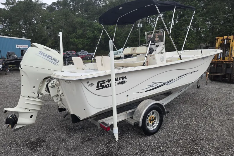 Slide: The Image of 2019 Carolina Skiff 198 DLV boat with Suzuki outboard motor on trailer. - 3