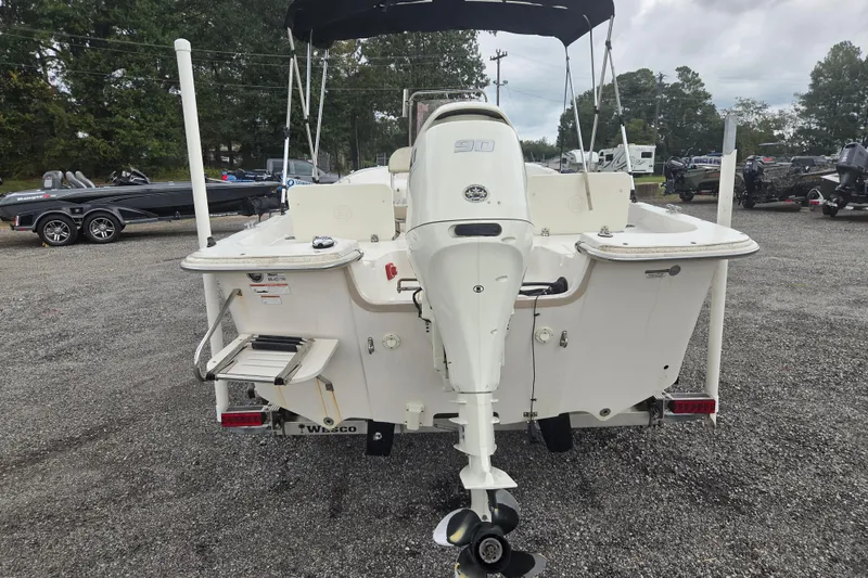 Slide: The Image of 2019 Carolina Skiff 198 DLV boat with outboard motor, parked on gravel lot. - 4