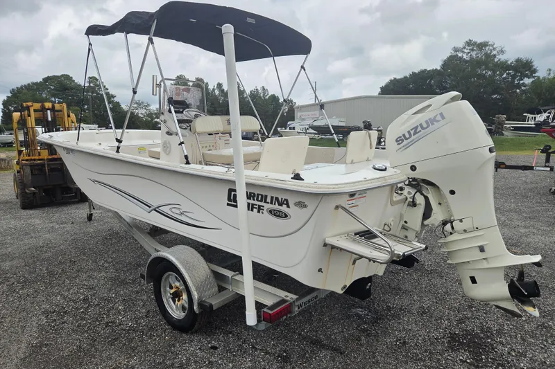 Slide: The Image of 2019 Carolina Skiff 198 DLV boat with Suzuki outboard motor on trailer. - 5