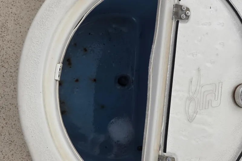 Slide: The Image of Open hatch on 2019 Carolina Skiff 198 DLV boat, showing interior compartment. - 8