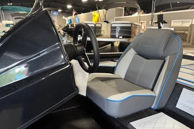Slide: The Image of 2026 Xpress H20 Bass boat interior with steering wheel and cushioned seat. - 10