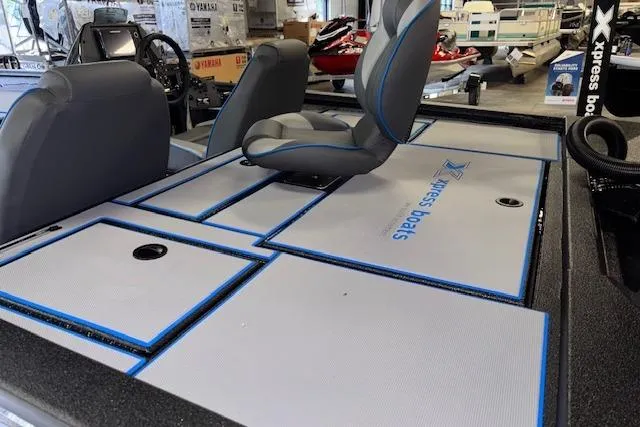 Slide: The Image of 2026 Xpress H20 Bass boat interior with seating and storage compartments. - 11