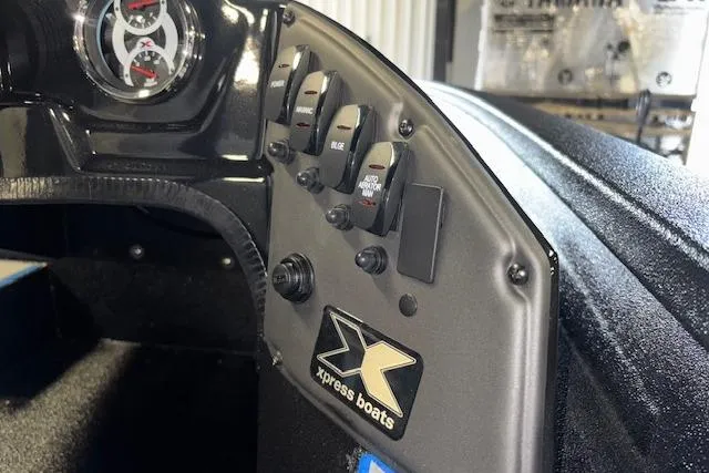Slide: The Image of Dashboard of 2026 Xpress H20 Bass boat with control switches and gauge. - 16