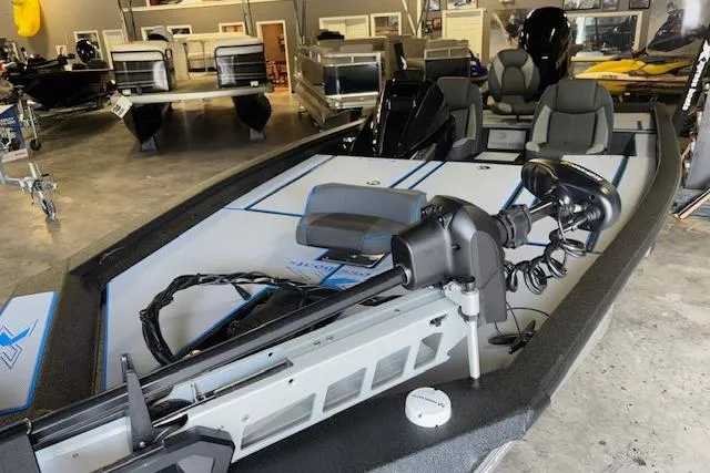 Slide: The Image of 2026 Xpress H20 Bass boat in showroom, featuring modern seating and equipment. - 3