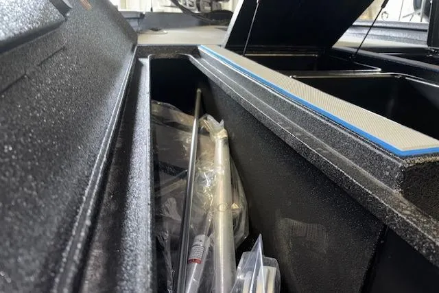 Slide: The Image of 2026 Xpress H20 Bass boat storage compartment with fishing gear and accessories. - 34