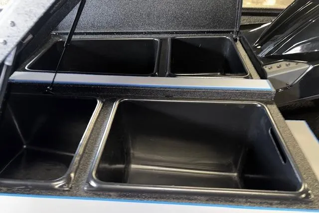 Slide: The Image of 2026 Xpress H20 Bass boat storage compartments, open and empty, showcasing interior space. - 35