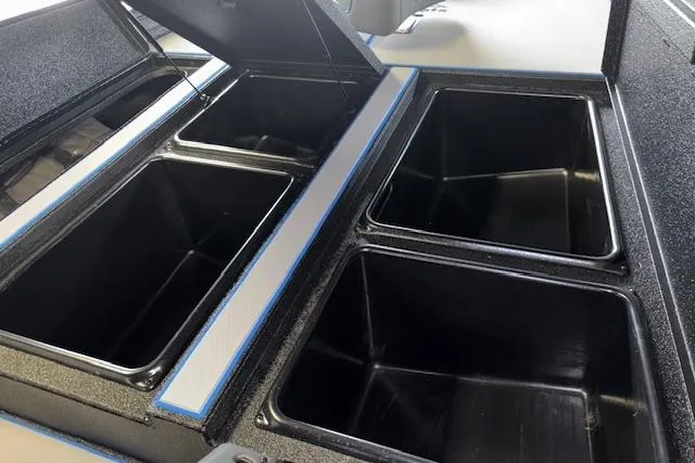 Slide: The Image of 2026 Xpress H20 Bass boat storage compartments, open and empty, showcasing spacious interior design. - 37