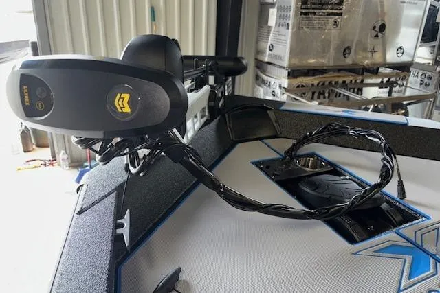 Slide: The Image of 2026 Xpress H20 Bass boat with advanced trolling motor in a storage area. - 7