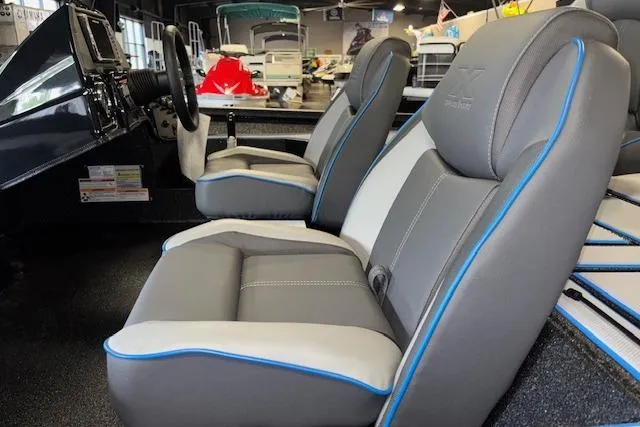 Slide: The Image of 2026 Xpress H20 Bass boat interior with gray and blue-trimmed seats. - 9