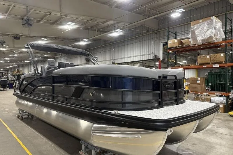 Slide: The Image of 2026 Bennington 24 MFBSF pontoon boat in a warehouse setting. - 11