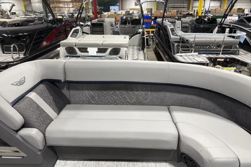 Slide: The Image of 2026 Bennington 24 MFBSF pontoon boat interior with luxurious seating in showroom. - 16
