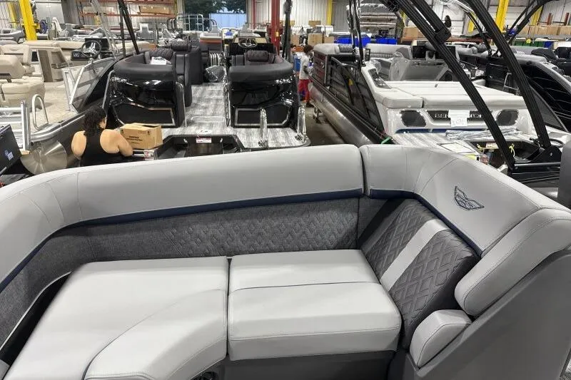Slide: The Image of 2026 Bennington 24 MFBSF pontoon boat interior in a showroom with other boats. - 18