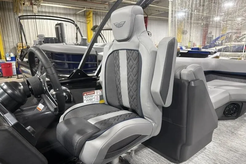 Slide: The Image of 2026 Bennington 24 MFBSF boat interior with luxurious captain's seat and steering wheel. - 22