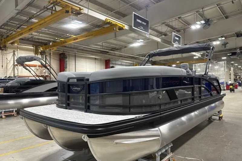Slide: The Image of 2026 Bennington 24 MFBSF pontoon boat in a factory setting, showcasing sleek design. - 5