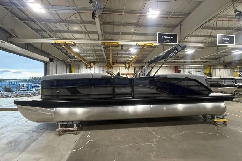 Slide: The Image of 2026 Bennington 24 MFBSF pontoon boat in a warehouse setting. - 6