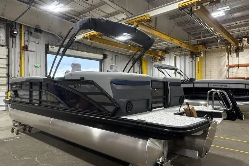 Slide: The Image of 2026 Bennington 24 MFBSF pontoon boat in a warehouse setting. - 7