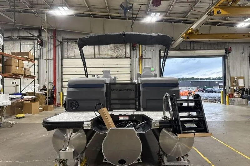 Slide: The Image of 2026 Bennington 24 MFBSF pontoon boat in a warehouse setting. - 8