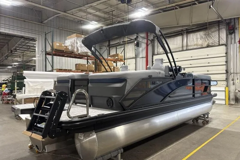 Slide: The Image of 2026 Bennington 24 MFBSF pontoon boat in a warehouse setting. - 9