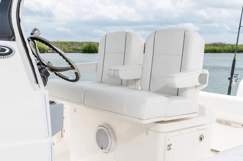 Slide: The Image of 2026 Pursuit S 268 Sport boat dashboard with steering wheel and electronic controls. - 13