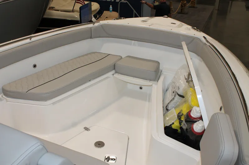 Slide: The Image of 2026 Pursuit S 268 Sport boat interior with gray seating and storage compartment. - 20