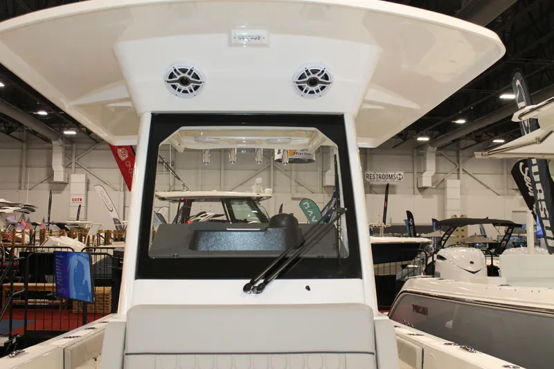 Slide: The Image of 2026 Pursuit S 268 Sport boat displayed at an indoor boat show. - 23