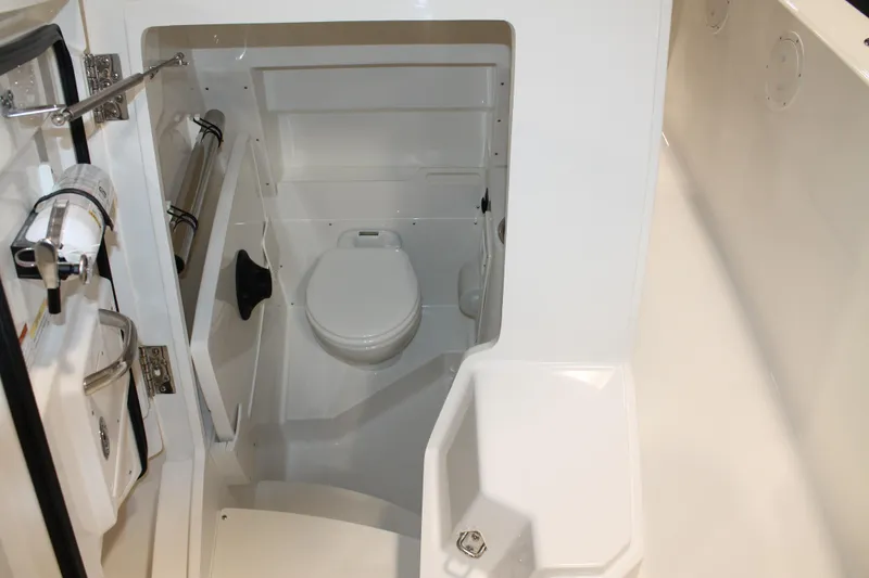 Slide: The Image of 2026 Pursuit S 268 Sport boat interior with compact marine toilet. - 24