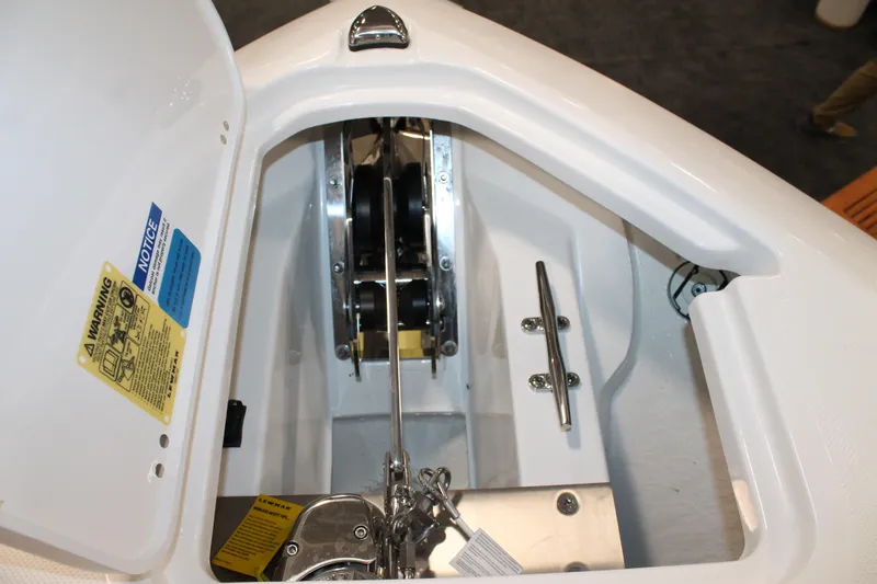 Slide: The Image of 2026 Pursuit S 268 Sport boat anchor compartment with winch and cleat. - 25