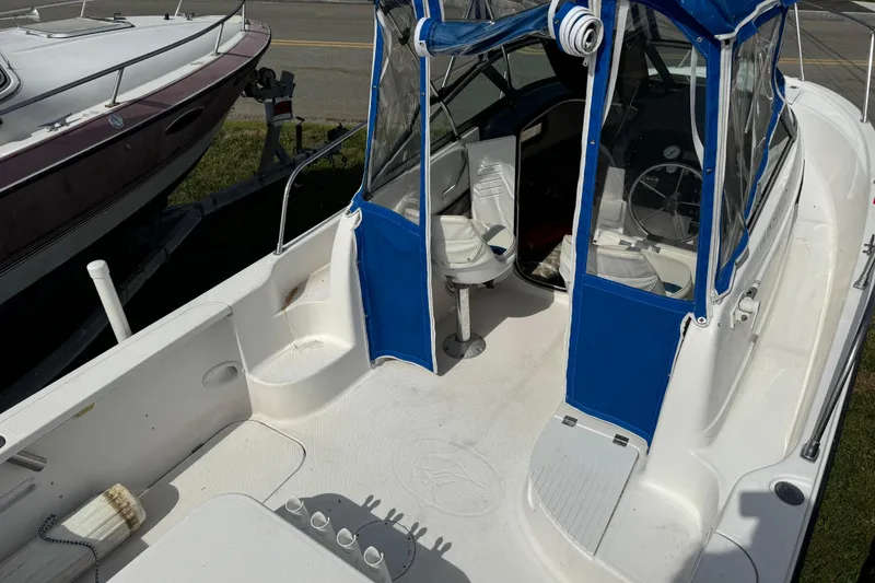 Slide: The Image of 1999 Trophy Bayliner boat interior with blue canopy and white seating. - 3