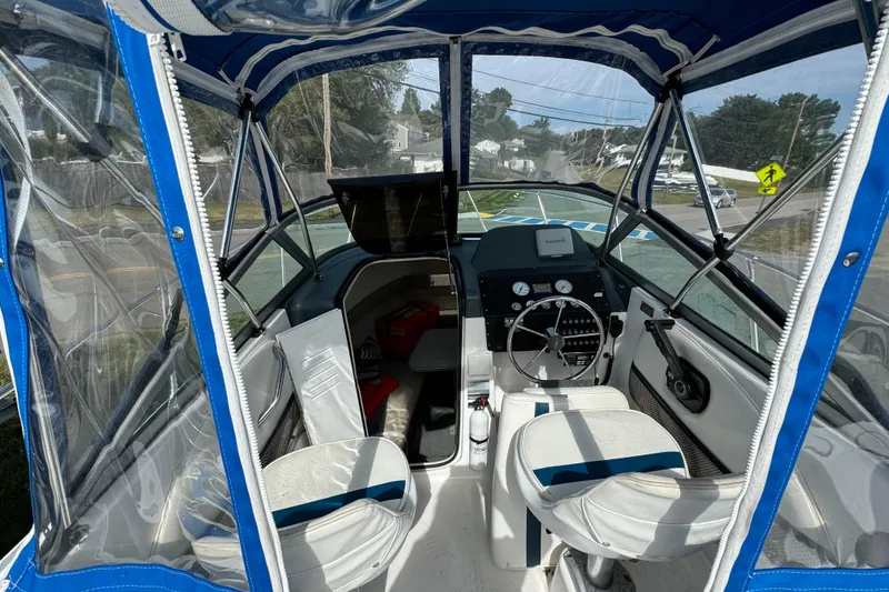 Slide: The Image of Interior view of a 1999 Trophy Bayliner boat with blue canopy and steering console. - 6