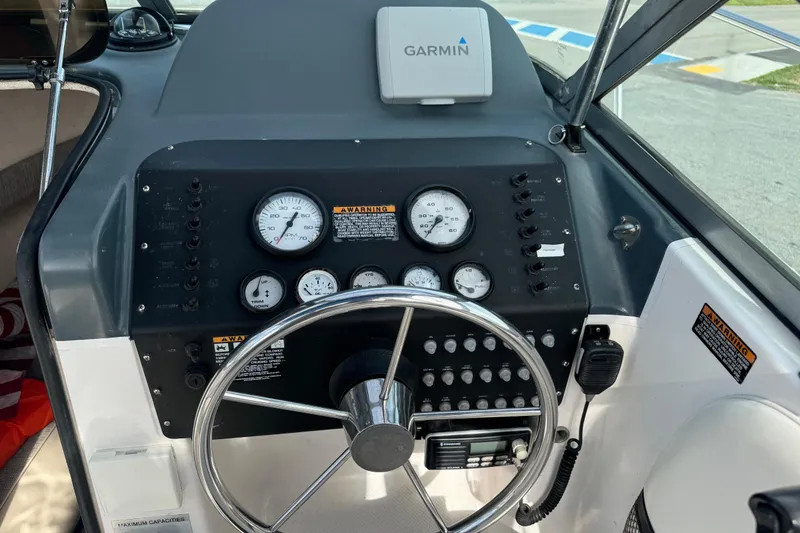 Slide: The Image of 1999 Trophy Bayliner boat dashboard with Garmin GPS and control gauges. - 8