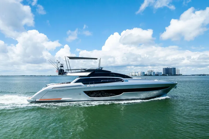 The Image of 2023 Riva 76 PERSEO Super yacht cruising on open water under a blue sky. - 0