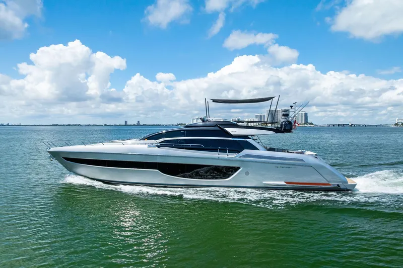 Slide: The Image of 2023 Riva 76 PERSEO Super yacht cruising on open water under a blue sky. - 3