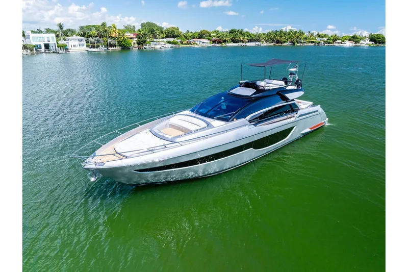 Slide: The Image of Luxury 2023 Riva 76 PERSEO Super yacht cruising on a serene, sunny waterway. - 8