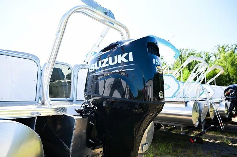 Slide: The Image of 2023 Aloha Pontoon Mahalo 23 with Suzuki outboard motor, parked outdoors. - 5