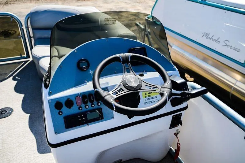 Slide: The Image of 2023 Aloha Pontoon Mahalo 23 boat dashboard with steering wheel and controls. - 6