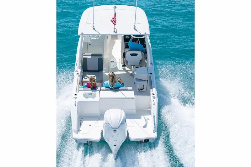 Slide: The Image of 2026 Pursuit DC 246 Dual Console boat on trailer in showroom. - 3