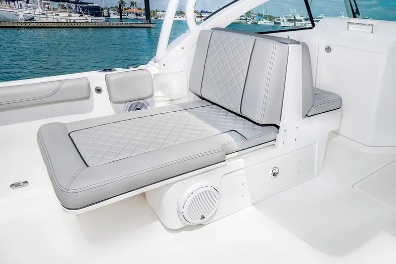 Slide: The Image of 2026 Pursuit DC 246 Dual Console boat interior with luxurious seating in showroom. - 9