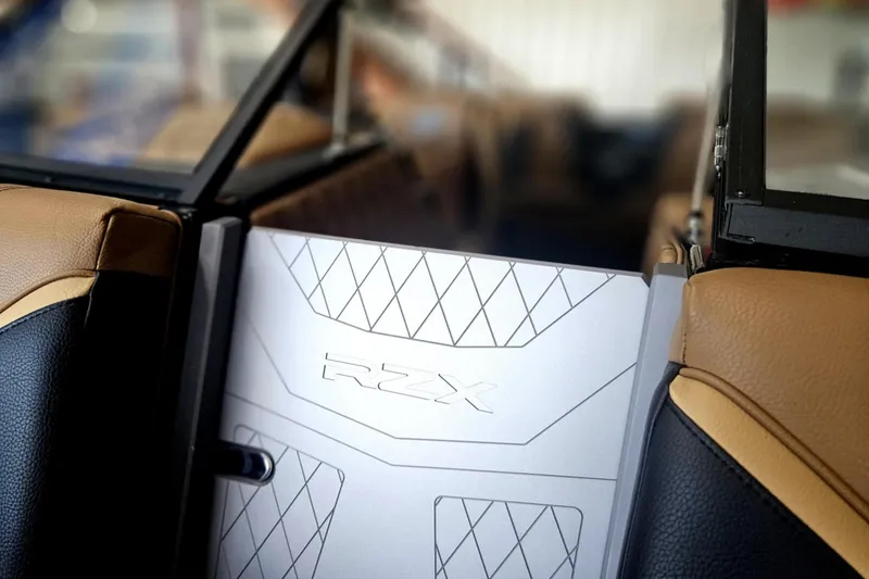 Slide: The Image of 2025 Tigé 22RZX boat interior with RZX logo and luxury seating. - 10