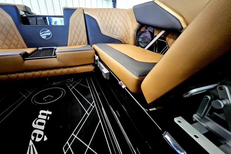 Slide: The Image of 2025 Tigé 22RZX interior with luxurious brown leather seating and modern design elements. - 11
