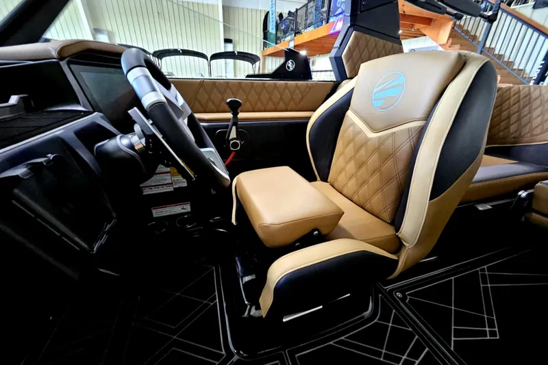Slide: The Image of 2025 Tigé 22RZX boat interior with luxurious tan leather seating and modern dashboard. - 14