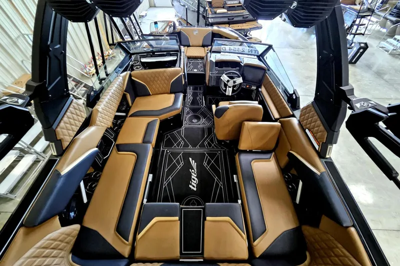 Slide: The Image of Interior of 2025 Tigé 22RZX boat with luxurious tan and black seating. - 18