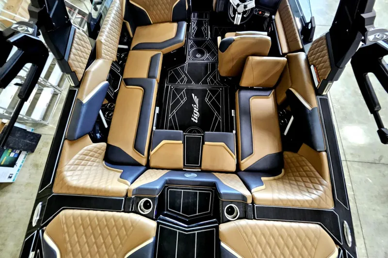 Slide: The Image of Luxurious interior of 2025 Tigé 22RZX boat with tan and black seating. - 19