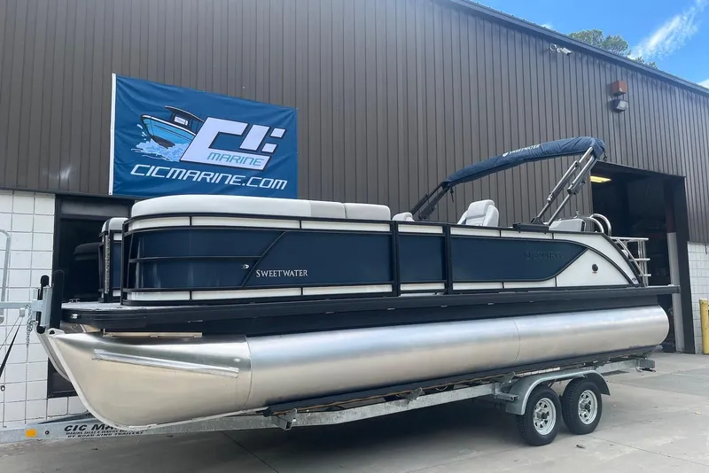 The Image of 2026 Godfrey SWEETWATER 2286 SFL pontoon boat on trailer outside CIC Marine building. - 0