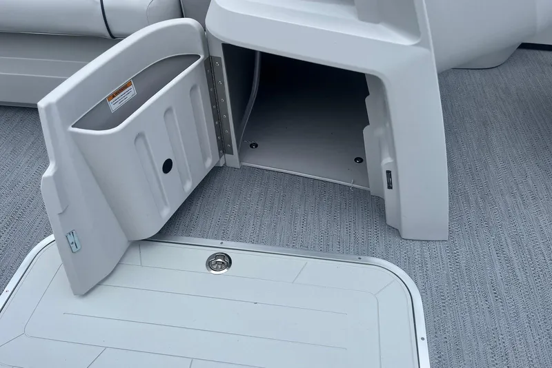 Slide: The Image of Open storage compartment on 2026 Godfrey SWEETWATER 2286 SFL boat, featuring gray flooring. - 11