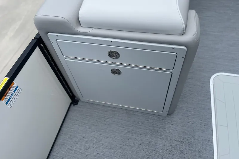 Slide: The Image of 2026 Godfrey SWEETWATER 2286 SFL boat interior storage compartment with cushioned seating. - 12