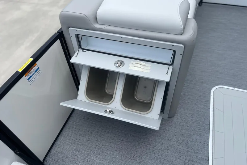 Slide: The Image of Interior storage compartment on 2026 Godfrey SWEETWATER 2286 SFL boat, featuring dual bins. - 13