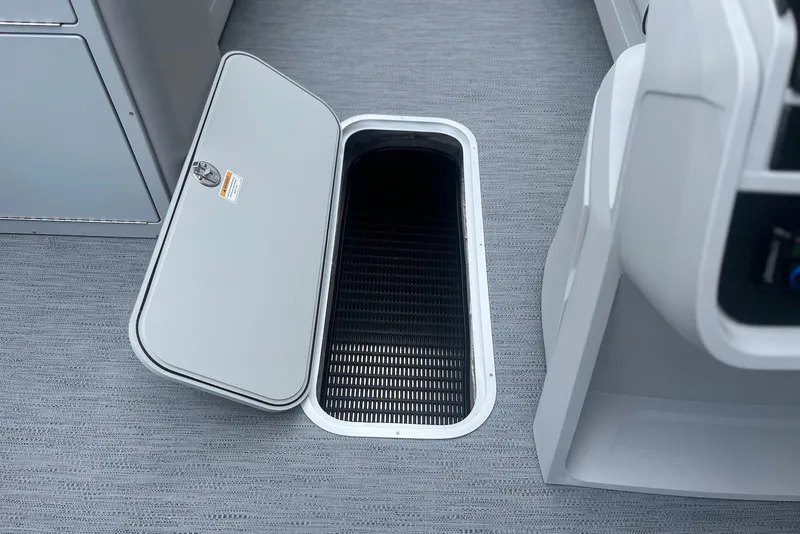 Slide: The Image of Open storage compartment on 2026 Godfrey SWEETWATER 2286 SFL boat, featuring sleek interior design. - 14